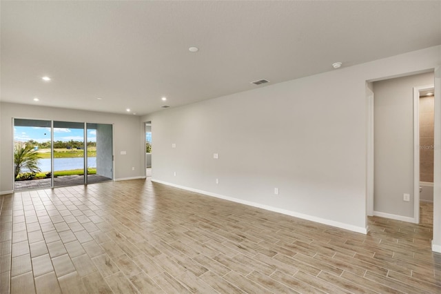 17800 Solstice Ave, Venice, FL 34293 - empty room featuring light wood-style floors, recessed lighting, visible vents, and baseboards
