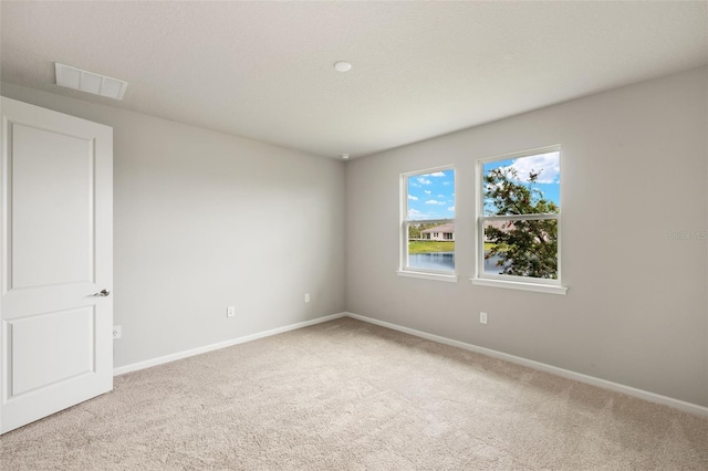 17800 Solstice Ave, Venice, FL 34293 - spare room with visible vents, baseboards, and light carpet