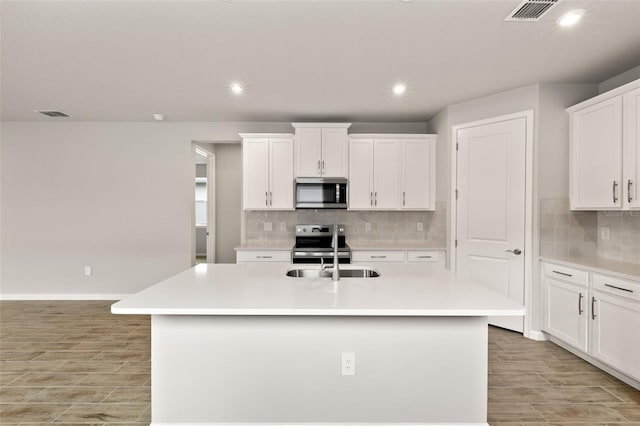 17800 Solstice Ave, Venice, FL 34293 - kitchen featuring recessed lighting, visible vents, appliances with stainless steel finishes, light wood finished floors, and a sink