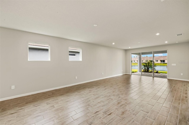 17800 Solstice Ave, Venice, FL 34293 - unfurnished room featuring light wood-style floors, baseboards, visible vents, and recessed lighting
