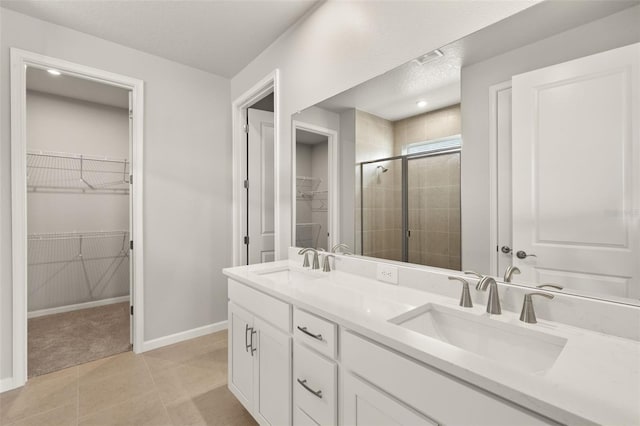 17800 Solstice Ave, Venice, FL 34293 - bathroom with a shower stall, a walk in closet, double vanity, and a sink
