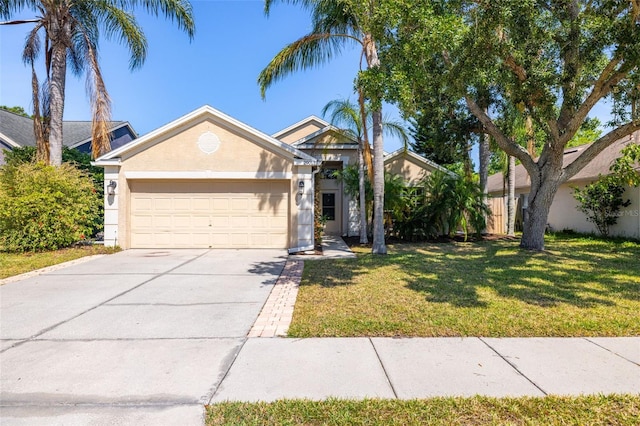 view of front of house featuring stucco siding, driveway, a front yard, and a garage