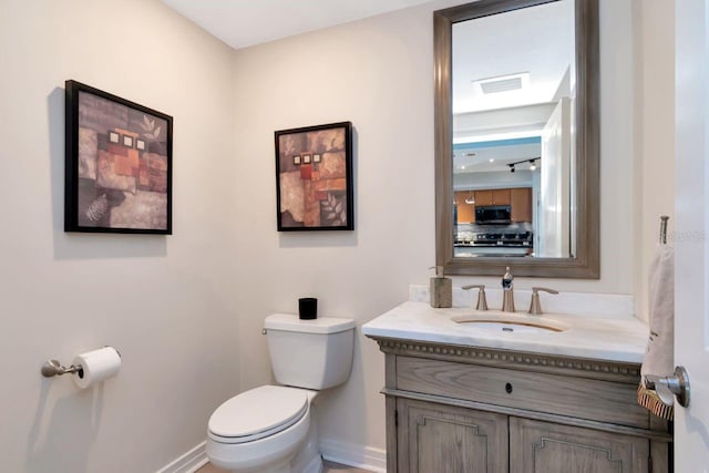 1350 Gulf Blvd Unit 301, Clearwater Beach, FL 33767 - bathroom featuring visible vents, toilet, baseboards, and vanity