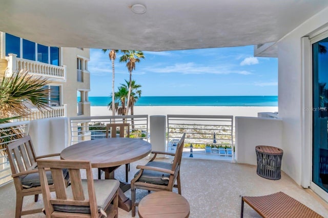 1350 Gulf Blvd Unit 301, Clearwater Beach, FL 33767 - balcony with a beach view, outdoor dining area, and a water view