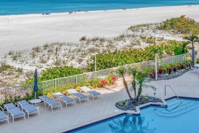 1350 Gulf Blvd Unit 301, Clearwater Beach, FL 33767 - pool featuring a beach view, a water view, a patio, and a fenced backyard