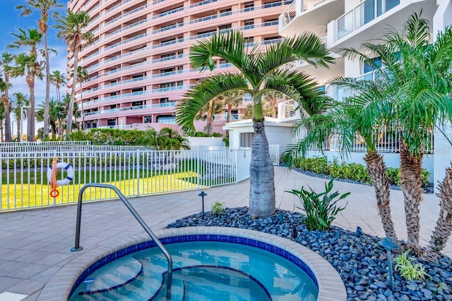 1350 Gulf Blvd Unit 301, Clearwater Beach, FL 33767 - view of pool with fence and a hot tub