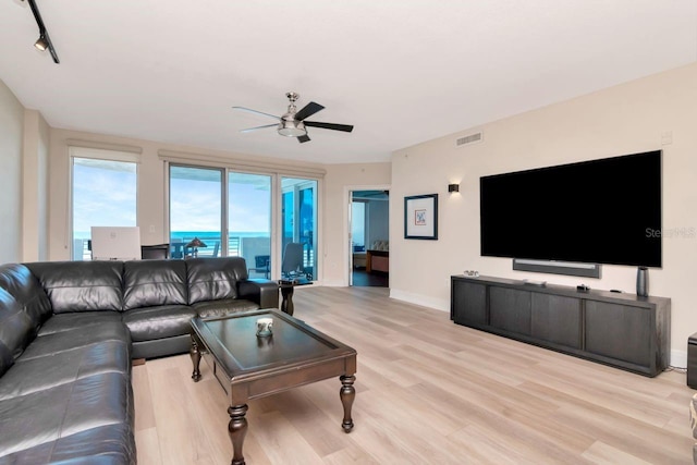 1350 Gulf Blvd Unit 301, Clearwater Beach, FL 33767 - living area with ceiling fan, baseboards, light wood finished floors, and visible vents