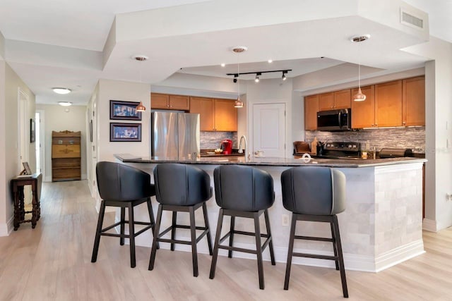 1350 Gulf Blvd Unit 301, Clearwater Beach, FL 33767 - kitchen featuring backsplash, light wood-type flooring, visible vents, and stainless steel appliances