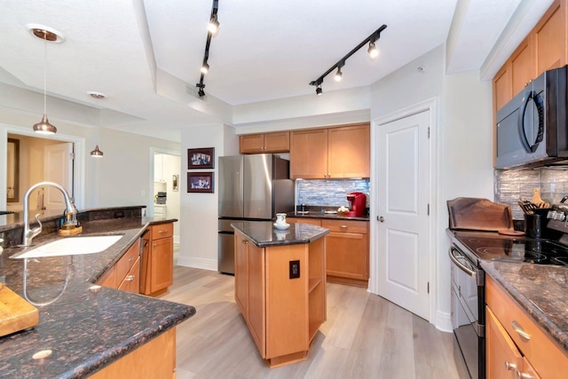 1350 Gulf Blvd Unit 301, Clearwater Beach, FL 33767 - kitchen featuring a sink, black appliances, light wood finished floors, rail lighting, and a kitchen island