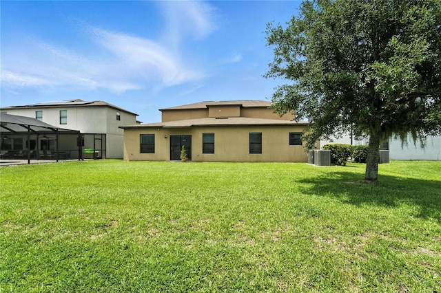 14050 Arbor Pines Dr, Riverview, FL 33579 - rear view of property featuring a lawn, stucco siding, and glass enclosure