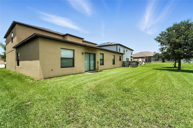 14050 Arbor Pines Dr, Riverview, FL 33579 - rear view of property featuring stucco siding and a yard