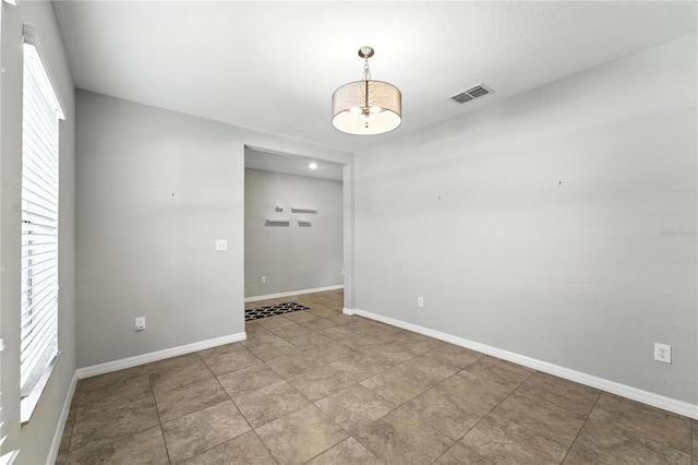 14050 Arbor Pines Dr, Riverview, FL 33579 - spare room featuring a chandelier and baseboards