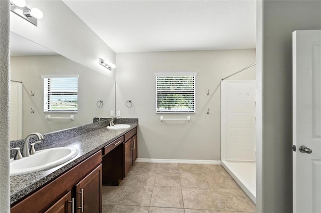 14050 Arbor Pines Dr, Riverview, FL 33579 - bathroom with plenty of natural light, a stall shower, double vanity, and tile patterned floors