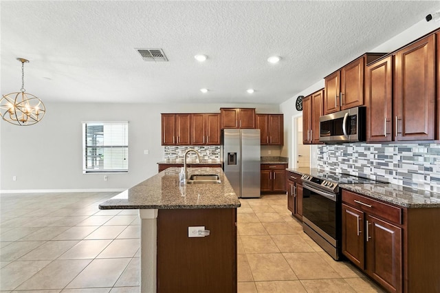 14050 Arbor Pines Dr, Riverview, FL 33579 - kitchen featuring appliances with stainless steel finishes, tasteful backsplash, a chandelier, a center island with sink, and dark stone countertops