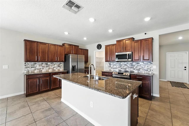 14050 Arbor Pines Dr, Riverview, FL 33579 - kitchen with appliances with stainless steel finishes, tasteful backsplash, light tile patterned flooring, recessed lighting, and a textured ceiling