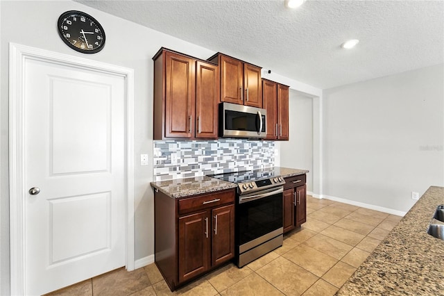14050 Arbor Pines Dr, Riverview, FL 33579 - kitchen featuring stainless steel appliances, backsplash, stone countertops, light tile patterned floors, and a textured ceiling