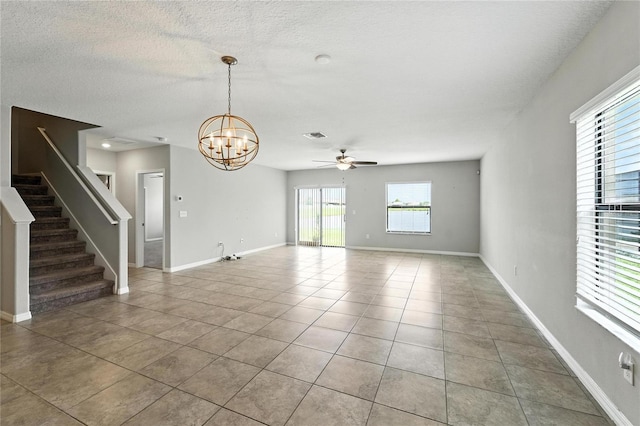 14050 Arbor Pines Dr, Riverview, FL 33579 - unfurnished living room with ceiling fan, light tile patterned floors, a chandelier, stairs, and a textured ceiling
