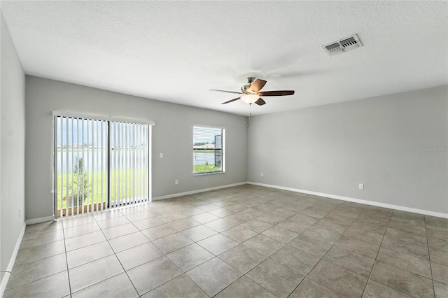 14050 Arbor Pines Dr, Riverview, FL 33579 - empty room featuring a ceiling fan, tile patterned floors, and a textured ceiling