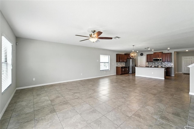 14050 Arbor Pines Dr, Riverview, FL 33579 - unfurnished living room with healthy amount of natural light, a ceiling fan, recessed lighting, and light tile patterned flooring