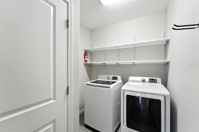 14050 Arbor Pines Dr, Riverview, FL 33579 - laundry room featuring washing machine and clothes dryer and a textured ceiling