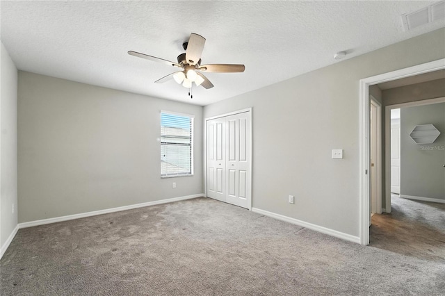 14050 Arbor Pines Dr, Riverview, FL 33579 - unfurnished bedroom featuring carpet flooring, a closet, a ceiling fan, and a textured ceiling