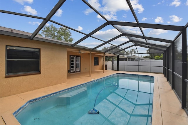 view of swimming pool with ceiling fan, a patio, a fenced in pool, and glass enclosure