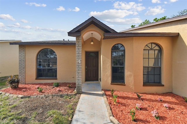 view of exterior entry with stucco siding