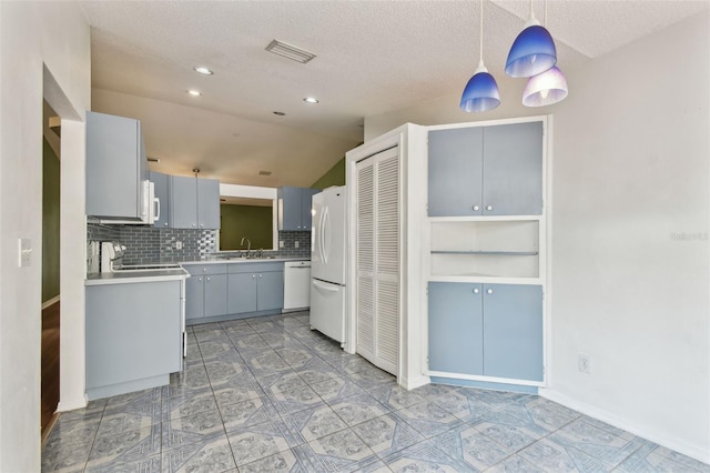 kitchen featuring hanging light fixtures, white appliances, visible vents, light countertops, and tasteful backsplash