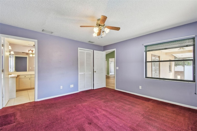 unfurnished bedroom with baseboards, carpet flooring, a closet, and visible vents