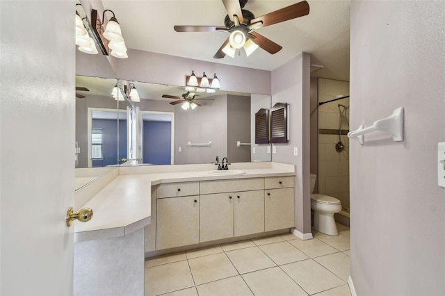 full bath with a ceiling fan, toilet, a tile shower, tile patterned flooring, and vanity