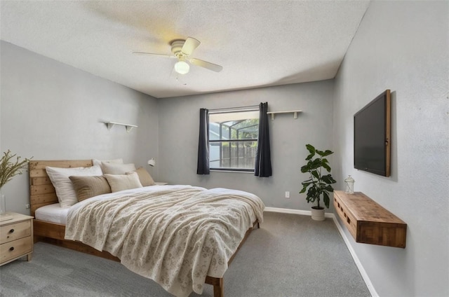 bedroom with baseboards, ceiling fan, carpet flooring, and a textured ceiling