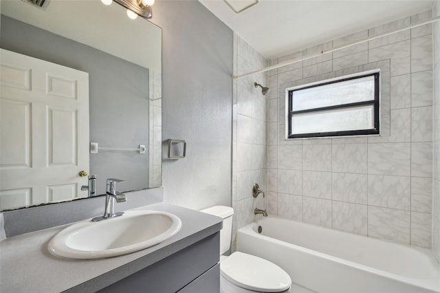 bathroom featuring a textured wall, toilet, vanity, and washtub / shower combination