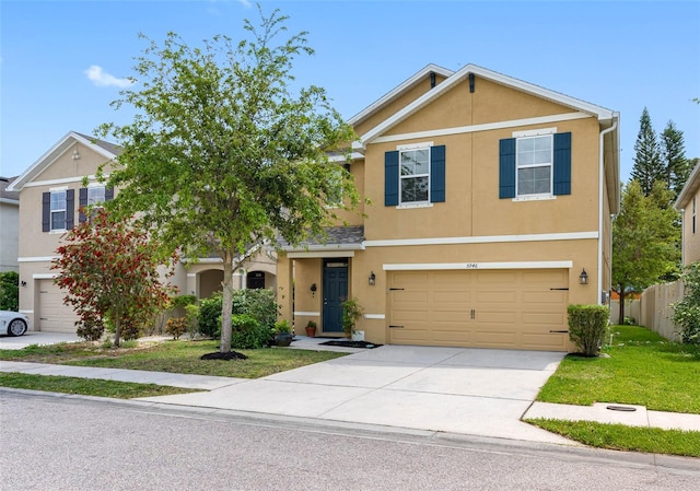5946 81st Ave N, Pinellas Park, FL 33781 - view of front of home with stucco siding, fence, driveway, a front yard, and a garage