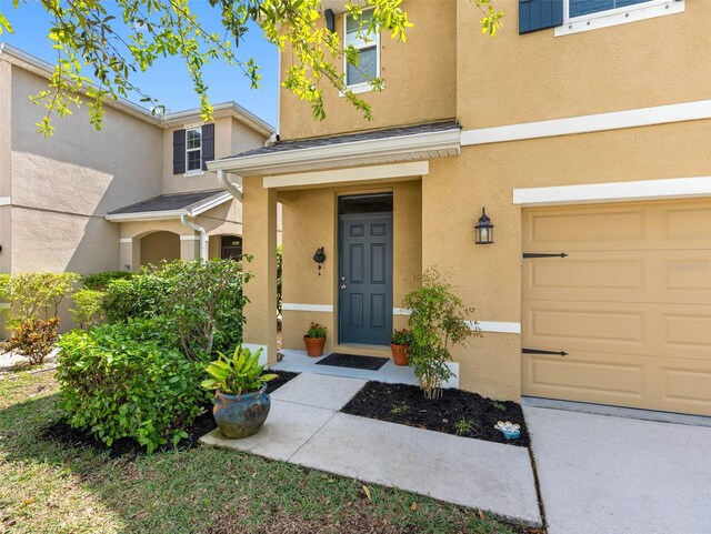 5946 81st Ave N, Pinellas Park, FL 33781 - property entrance with stucco siding and a garage