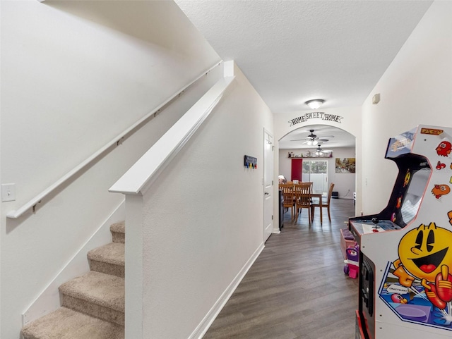 5946 81st Ave N, Pinellas Park, FL 33781 - interior space with a textured ceiling, baseboards, wood finished floors, stairway, and arched walkways