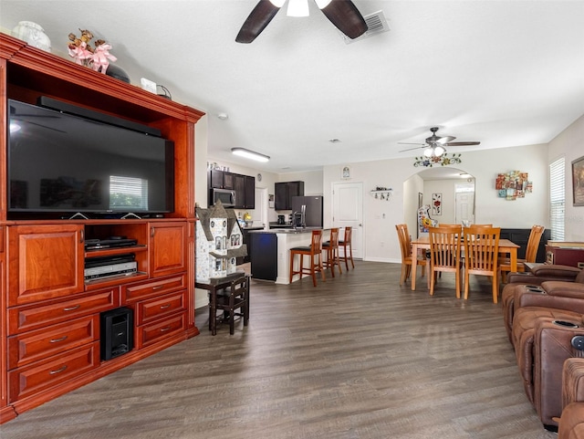 5946 81st Ave N, Pinellas Park, FL 33781 - living area featuring a ceiling fan, dark wood finished floors, baseboards, visible vents, and arched walkways
