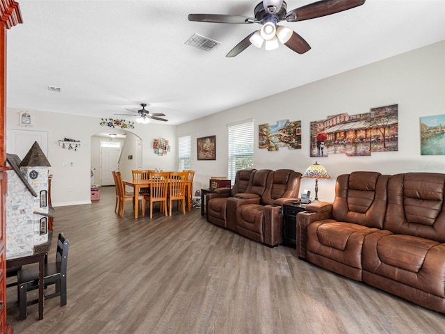 5946 81st Ave N, Pinellas Park, FL 33781 - living room with visible vents, wood finished floors, arched walkways, and a ceiling fan