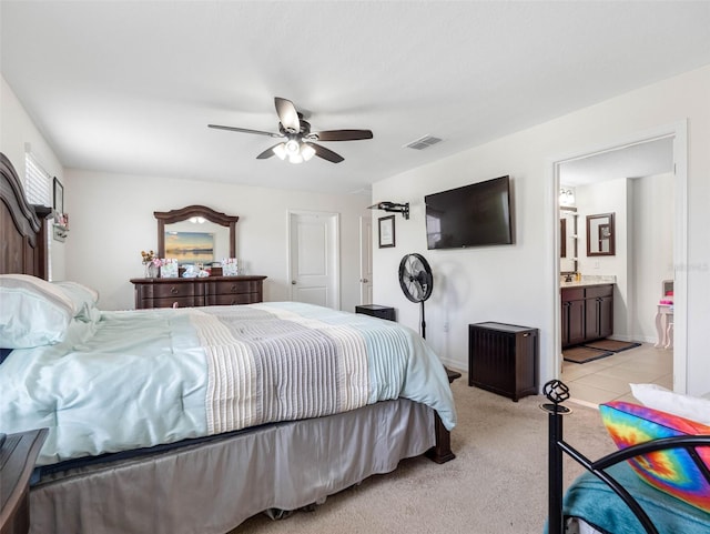 5946 81st Ave N, Pinellas Park, FL 33781 - bedroom with a ceiling fan, connected bathroom, light colored carpet, and visible vents