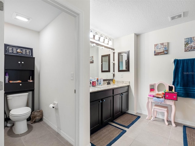 5946 81st Ave N, Pinellas Park, FL 33781 - bathroom with vanity, toilet, a textured ceiling, tile patterned floors, and visible vents