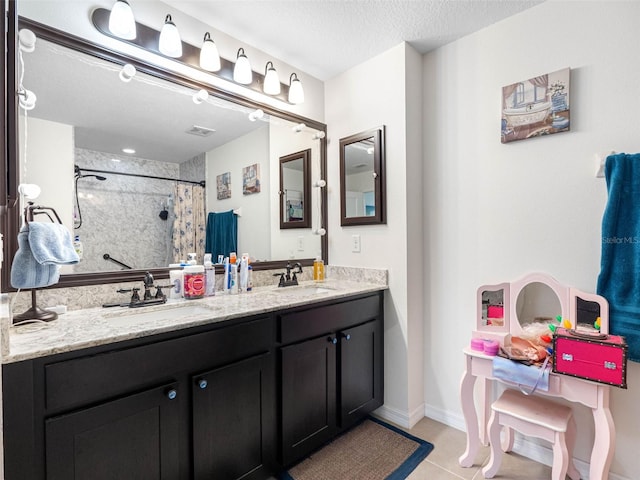 5946 81st Ave N, Pinellas Park, FL 33781 - bathroom with tile patterned floors, a sink, a shower with curtain, a textured ceiling, and double vanity