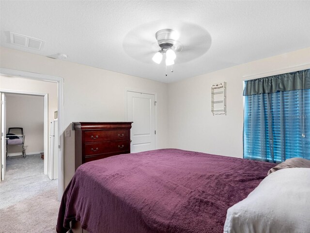 5946 81st Ave N, Pinellas Park, FL 33781 - bedroom with light colored carpet, visible vents, ceiling fan, and a textured ceiling