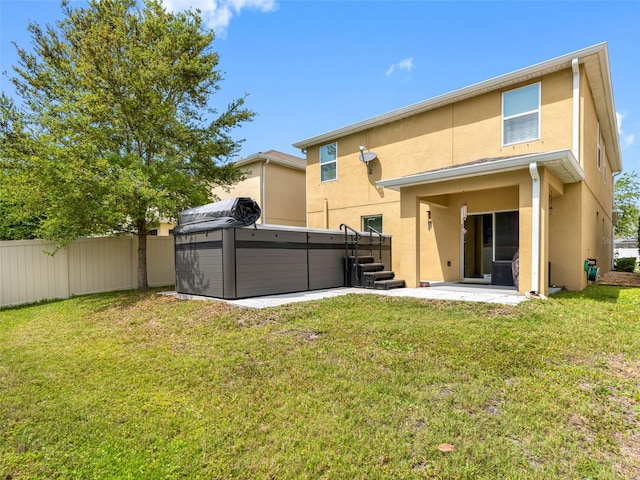 5946 81st Ave N, Pinellas Park, FL 33781 - back of property with stucco siding, fence, a hot tub, a patio, and a yard