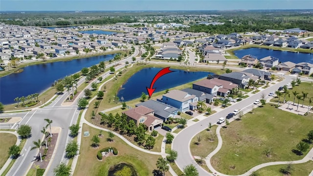 bird's eye view featuring a water view and a residential view