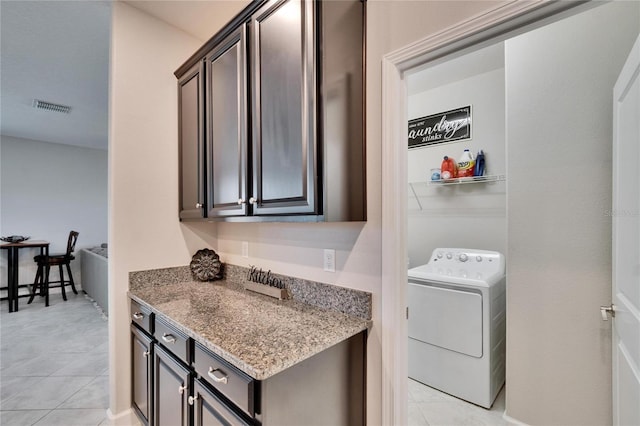 laundry room with light tile patterned floors, visible vents, washer / clothes dryer, and laundry area
