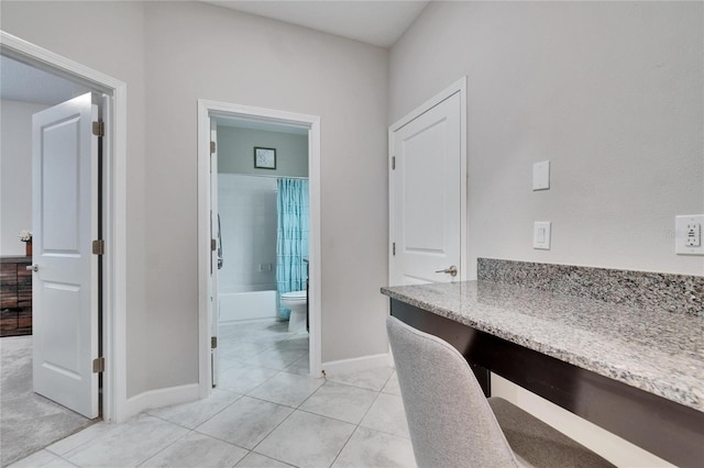 office with light tile patterned floors and baseboards
