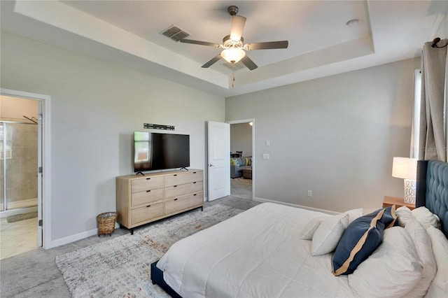 bedroom with carpet flooring, a raised ceiling, ceiling fan, visible vents, and baseboards
