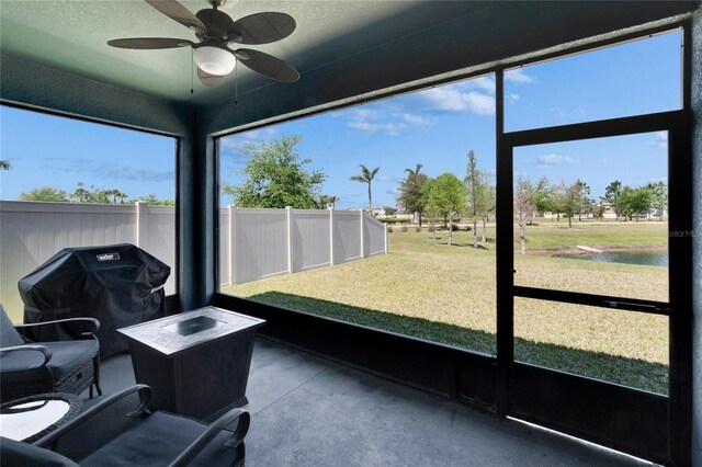 sunroom / solarium with a healthy amount of sunlight and a ceiling fan