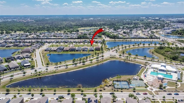 birds eye view of property featuring a water view and a residential view
