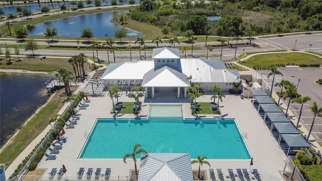 pool with a water view, a gazebo, and a patio area