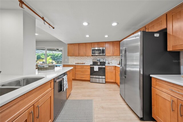 1810 Pine Hill Dr, Safety Harbor, FL 34695 - kitchen with stainless steel appliances, backsplash, recessed lighting, light countertops, and light wood-style flooring